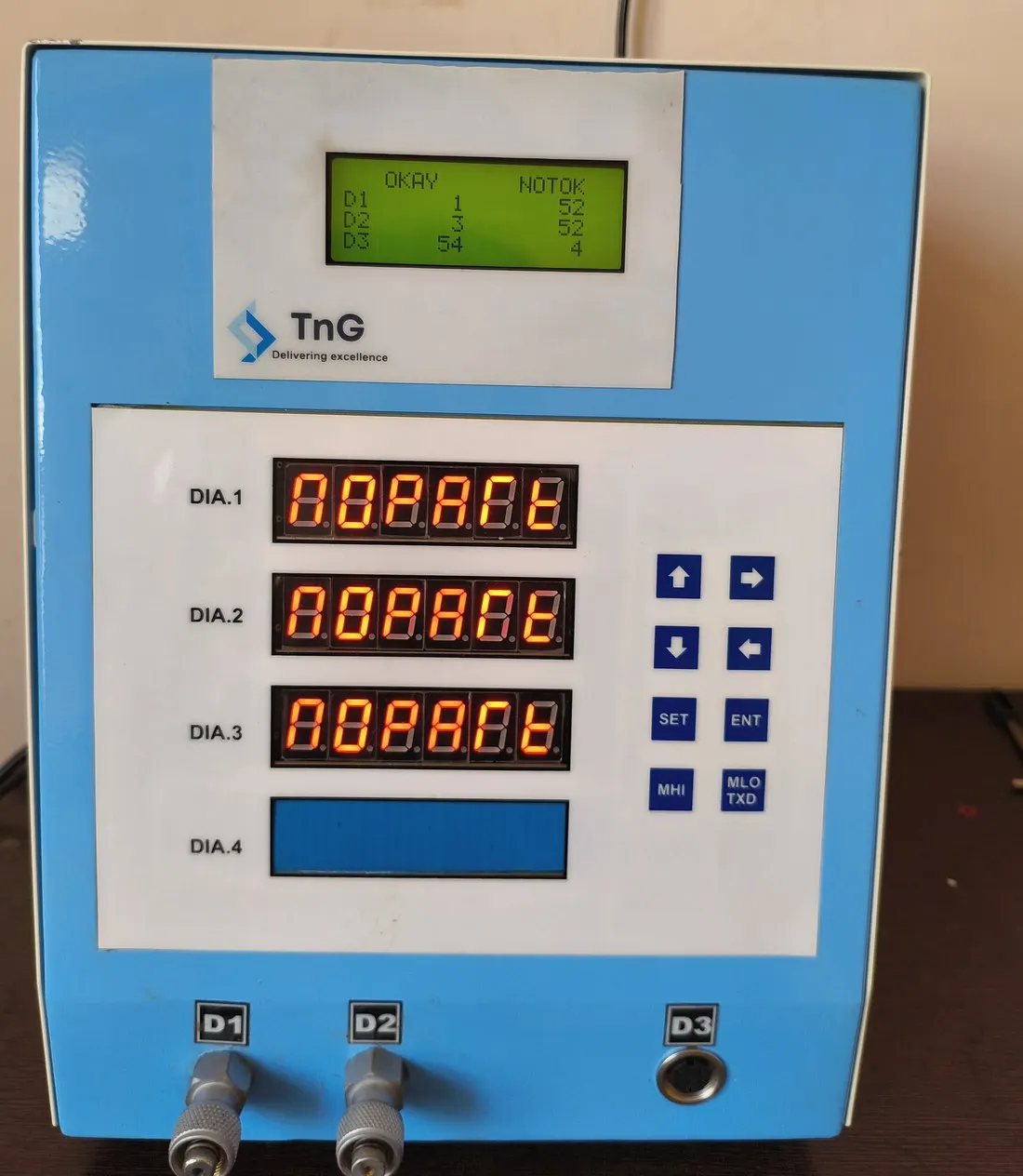 TnG digital gauge with three red LED readouts, a green LCD and a keypad.